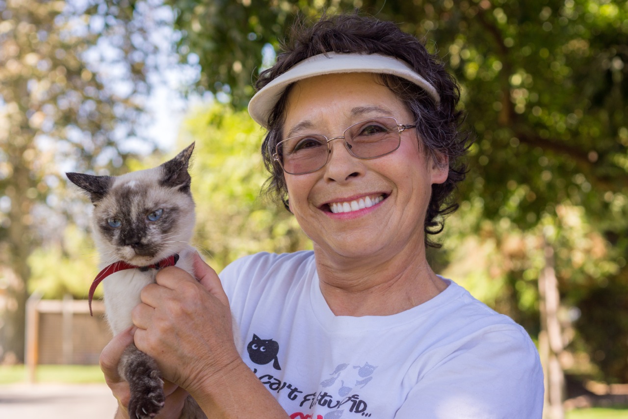Lynea holding a cat in the sanctuary gardens